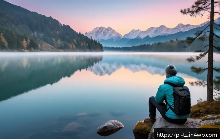 감정 해독과 자아 탐색을 위한 여행 - A peaceful mountain lake scene at sunrise, with a lone traveler sitting on a rock by the water’s edg...